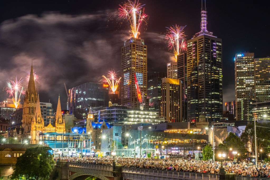 Fireworks erupt over the Melbourne central business district during New Year
