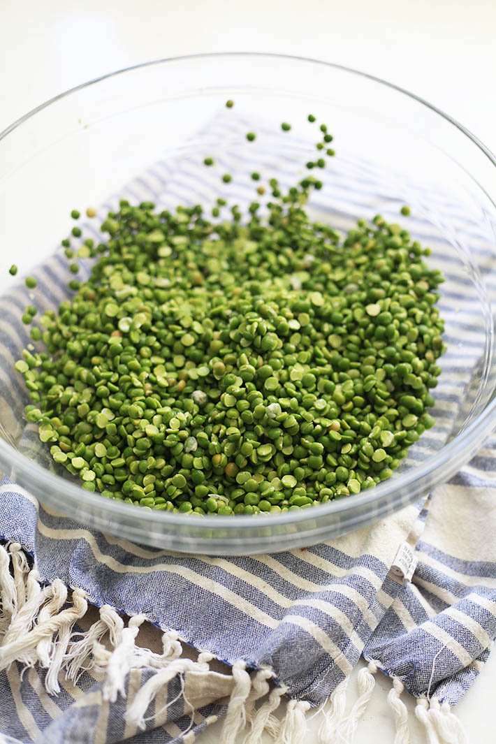 A glass bowl filled with rinsed split peas. 